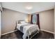 Cozy bedroom with a bed, bedside lamp, window, and soft carpet at 10774 Chadsworth Ln, Highlands Ranch, CO 80126