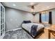 The gray bedroom includes a bed, bedside table, and window with dark curtains at 10774 Chadsworth Ln, Highlands Ranch, CO 80126