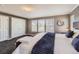 Comfortable bedroom with a large bed, big windows, and a double door closet at 10774 Chadsworth Ln, Highlands Ranch, CO 80126