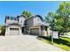 Charming two-story home with a three-car garage and meticulously landscaped front yard at 10774 Chadsworth Ln, Highlands Ranch, CO 80126
