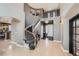 Grand foyer with a curved staircase, light wood floors and soaring ceilings at 10774 Chadsworth Ln, Highlands Ranch, CO 80126