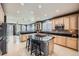 Large kitchen featuring an island and breakfast bar with seating at 10774 Chadsworth Ln, Highlands Ranch, CO 80126
