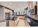 Spacious kitchen with a gas cooktop and black granite countertops at 10774 Chadsworth Ln, Highlands Ranch, CO 80126