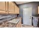 Laundry room with a sink, countertop, cabinets, and a modern washer-dryer set at 10774 Chadsworth Ln, Highlands Ranch, CO 80126