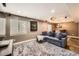 Spacious living room with a large sofa, plush rug, and natural light at 10774 Chadsworth Ln, Highlands Ranch, CO 80126
