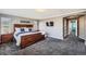 Inviting main bedroom featuring a statement wood bed frame and an archway to ensuite at 10774 Chadsworth Ln, Highlands Ranch, CO 80126