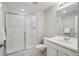 Modern bathroom featuring a glass-enclosed shower, white cabinets, and sleek fixtures at 13275 E Caley Pl, Centennial, CO 80111
