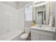 Bright bathroom with a shower-tub combination, a white vanity, and tiled floor at 13275 E Caley Pl, Centennial, CO 80111