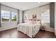 Bright bedroom with hardwood floors, white walls, and plenty of natural light from three large windows at 13275 E Caley Pl, Centennial, CO 80111