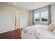 Comfortable bedroom with hardwood floors, a walk-in closet, and two large windows at 13275 E Caley Pl, Centennial, CO 80111