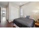 Inviting bedroom boasts hardwood floors, closet, and view into the hallway at 13275 E Caley Pl, Centennial, CO 80111