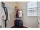 Walk-in closet with clothes hanging, luggage, wire shelving, and a window at 13275 E Caley Pl, Centennial, CO 80111