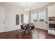 Cozy dining area with table, chairs, pendant lighting, and views of the outdoors through large windows at 13275 E Caley Pl, Centennial, CO 80111