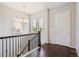 Bright foyer boasts hardwood floors, a staircase with iron railings, and plenty of natural light at 13275 E Caley Pl, Centennial, CO 80111