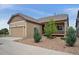 Well-manicured home with a mix of tan siding and stone accents, complemented by neat landscaping and a garage at 13275 E Caley Pl, Centennial, CO 80111