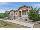 Attractive one-story home with stone accents and a covered porch, complimented by mature landscaping at 13275 E Caley Pl, Centennial, CO 80111
