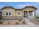 Charming single-story home featuring stone accents and a welcoming front porch, located at 13275 at 13275 E Caley Pl, Centennial, CO 80111