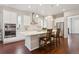 Bright kitchen boasts an island with bar seating, stainless steel appliances, and ample white cabinetry at 13275 E Caley Pl, Centennial, CO 80111