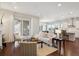 Open-concept living room flows into the kitchen, featuring hardwood floors and natural light at 13275 E Caley Pl, Centennial, CO 80111
