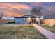 Charming backyard featuring a manicured lawn, privacy fence, and outdoor seating area at 4510 W 4Th Ave, Denver, CO 80219