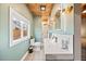 Stylist bathroom showcasing a wooden ceiling, white cabinets and an open view to the backyard at 4510 W 4Th Ave, Denver, CO 80219