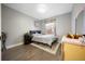 Cozy bedroom featuring hardwood floors, a comfy bed, and ample natural light at 4510 W 4Th Ave, Denver, CO 80219