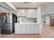 Butler pantry featuring shaker cabinets, subway tile backsplash, and stainless steel appliances, providing functionality at 4510 W 4Th Ave, Denver, CO 80219