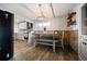 Cozy dining area with brick accent wall, modern lighting, and open access to the kitchen at 4510 W 4Th Ave, Denver, CO 80219