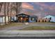 Charming home with a covered front porch, lovely brick driveway, and well-maintained lawn at 4510 W 4Th Ave, Denver, CO 80219
