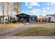 Inviting home with covered front porch, beautiful brick driveway and manicured lawn at 4510 W 4Th Ave, Denver, CO 80219
