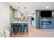 Modern kitchen featuring a breakfast bar, fireplace, and open layout perfect for entertaining guests at 4510 W 4Th Ave, Denver, CO 80219