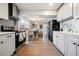 Bright kitchen with stainless steel appliances, tile backsplash, and hardwood flooring, offering a chef's dream space at 4510 W 4Th Ave, Denver, CO 80219