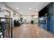 Spacious living room with fireplace, mounted TV, and a view into the modern kitchen at 4510 W 4Th Ave, Denver, CO 80219