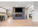 Open-concept living room with modern fireplace and adjacent kitchen and bedroom at 4510 W 4Th Ave, Denver, CO 80219