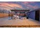 Relaxing outdoor patio area featuring a pergola, barbecue, and garden beds, ideal for evening gatherings at 4510 W 4Th Ave, Denver, CO 80219