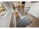 Carpeted staircase leading to the basement, featuring modern railings and ample lighting at 4510 W 4Th Ave, Denver, CO 80219