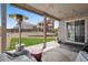 Covered patio showcasing an outdoor heater and landscaped backyard with grass and retaining wall in view at 4830 S Versailles St, Aurora, CO 80015