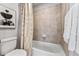 This bathroom features a toilet and tub and shower combo with a neutral colored shower curtain at 2087 Generations Aly, Brighton, CO 80601