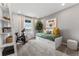 A charming bedroom with a bike and daybed complemented by a decorative plant and natural light from the window at 2087 Generations Aly, Brighton, CO 80601