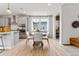 Bright dining area featuring a round table, stylish chairs, and large windows for natural light at 2087 Generations Aly, Brighton, CO 80601