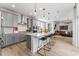 Modern kitchen with gray cabinets, stainless steel appliances, a white backsplash, and an island with seating at 2087 Generations Aly, Brighton, CO 80601