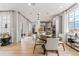 Spacious open-concept space includes kitchen, dining, and living areas with hardwood floors and recessed lighting at 2087 Generations Aly, Brighton, CO 80601