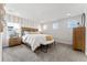 Serene main bedroom featuring neutral colors, a large bed, and a side table with a lamp at 2087 Generations Aly, Brighton, CO 80601