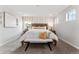 Beautiful main bedroom with soft lighting, a cozy bench, and windows that provide natural light at 2087 Generations Aly, Brighton, CO 80601