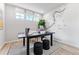 Home office featuring a black desk, natural light, and a decorative Colorado trail map accent wall at 2087 Generations Aly, Brighton, CO 80601