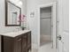 Bathroom featuring dark wood cabinets and a bright marble countertop with an open shower at 3269 Uinta St, Denver, CO 80238