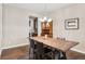 Elegant dining room with a rustic wood table, modern chandelier, and hardwood floors at 3269 Uinta St, Denver, CO 80238