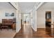 Long hallway featuring hardwood floors and neutral walls, leading to various rooms in the home at 3269 Uinta St, Denver, CO 80238