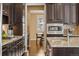 A kitchen featuring granite counters, and dark wood cabinets with stainless steel appliances at 3269 Uinta St, Denver, CO 80238