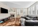 Cozy living room featuring hardwood floors, a fireplace, and a comfortable leather sofa at 3269 Uinta St, Denver, CO 80238